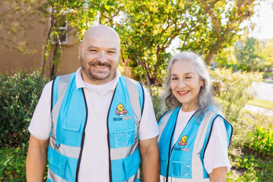 Two uniformed adults together.