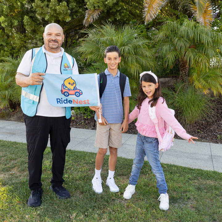 Portrait of a uniformed adult with two youths.