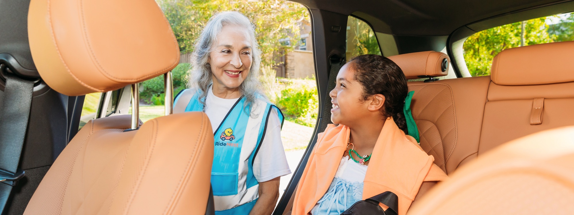 A Nest Driver making sure a rider is buckled in